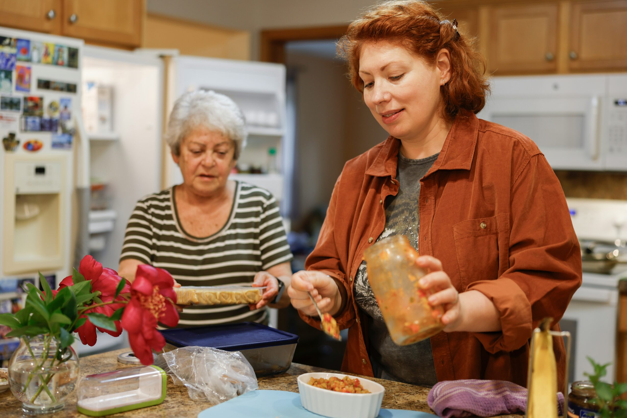 two women in kitchen preparing food